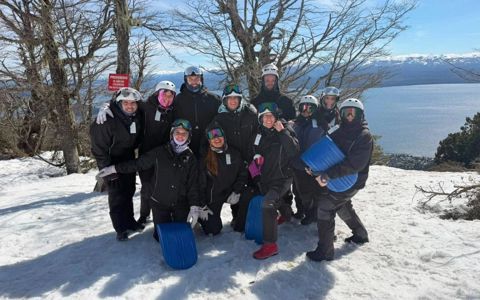 El grupo en la nieve, con los culipatines, frente al lago Nahuel Huapi